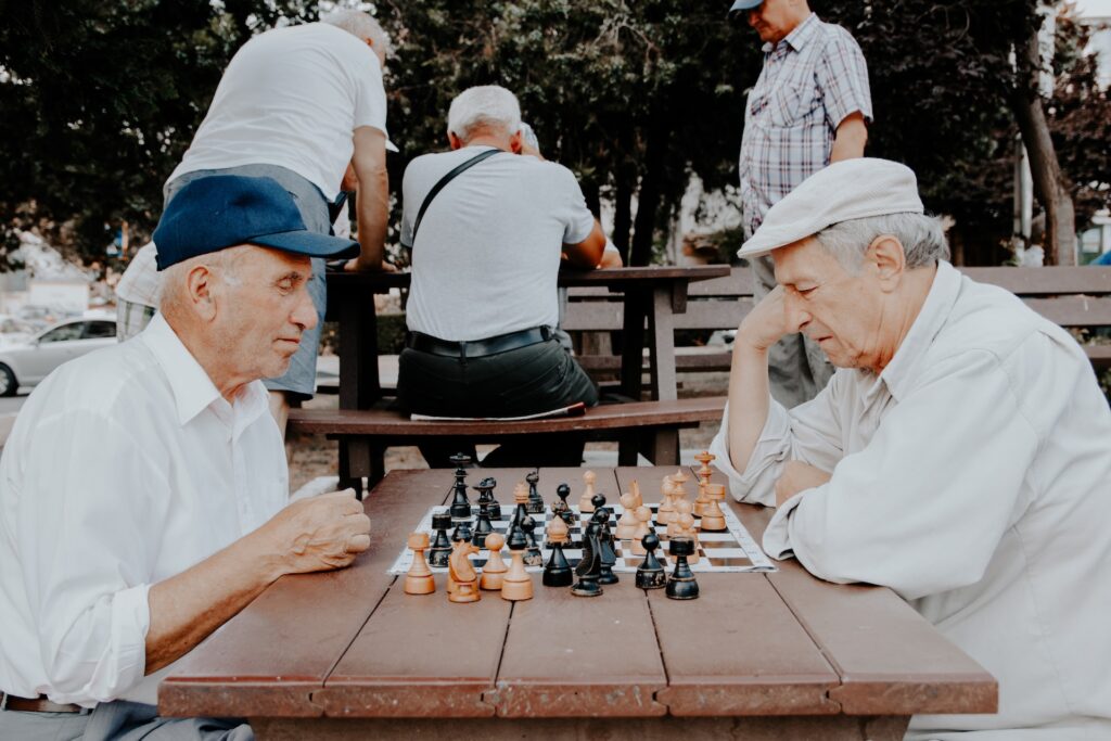 senior men playing chess at assisted living facility